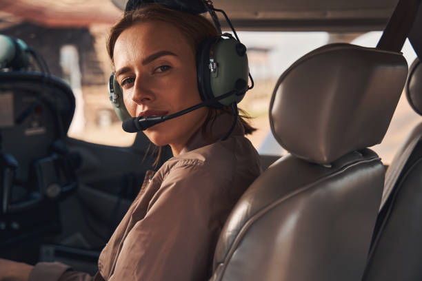 istock Beautiful young woman sitting inside plane cockpit 1325031669