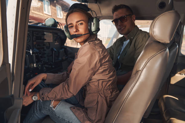 istock Beautiful woman and man sitting inside plane cockpit 1325031694