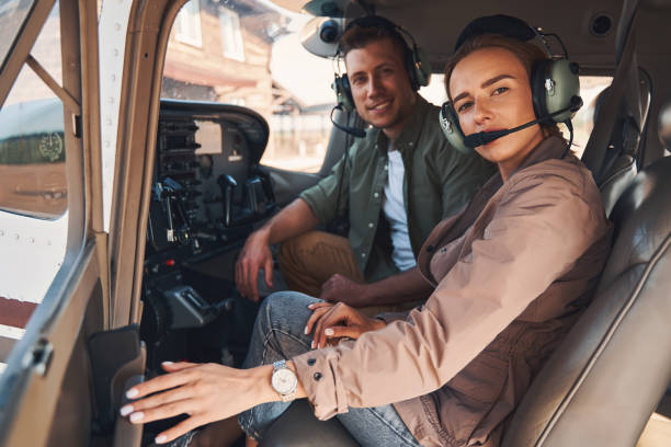 istock Cheerful man and woman sitting inside plane cockpit 1325031696
