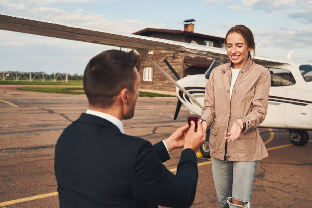 istock Man in love making proposal to his girlfriend at airdrome 1325031852
