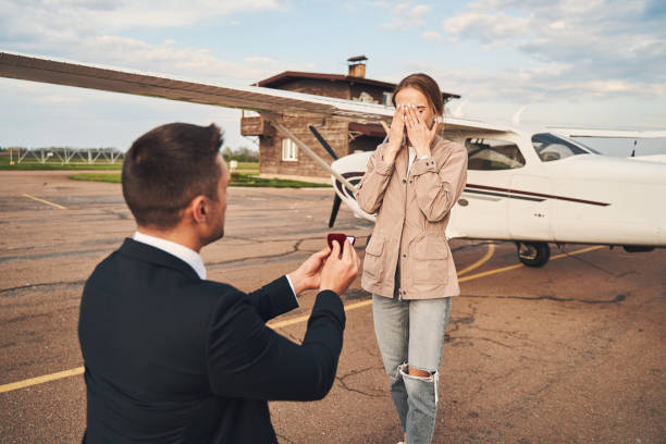 istock Loving man making proposal to his girlfriend at airdrome 1325031856