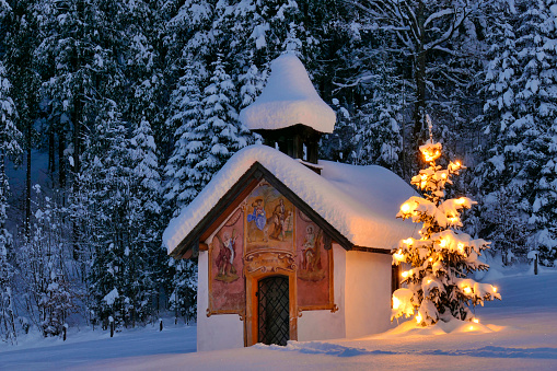 Illuminated Christmas tree in front of a chapel in winter, Bavaria, Upper Bavaria, Germany, Europe