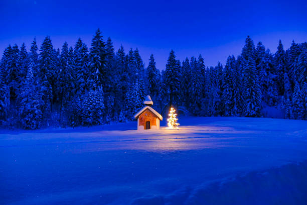Illuminated Christmas tree in front of a chapel in winter, Bavaria, Upper Bavaria, Germany, Europe