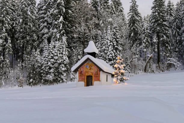 Illuminated Christmas tree in front of a chapel in winter, Bavaria, Upper Bavaria, Germany, Europe