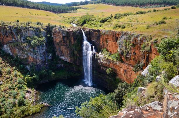 Berlin Falls Waterfall in Mpumalanga South Africa where a stream of water drops cliff into a lake Berlin Falls Waterfall in Mpumalanga South Africa where a stream of water drops cliff into a lake blyde river canyon stock pictures, royalty-free photos & images