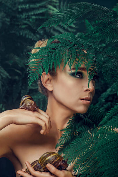 istock Mother Nature figure with snails 1325034469