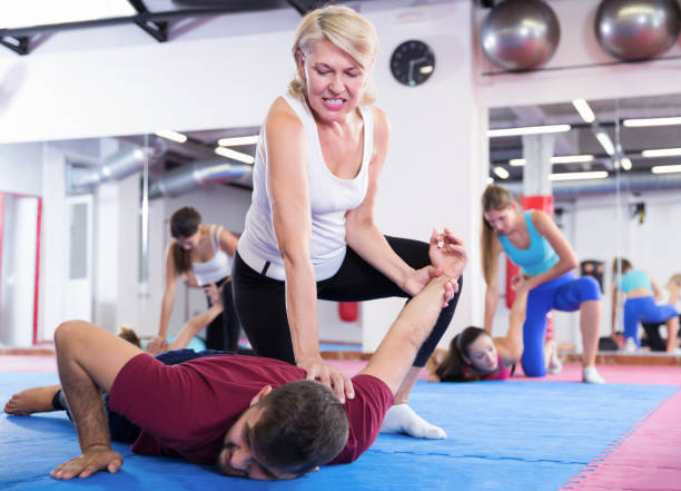 istock Mature female exercise self-defence moves with coach 1325034702