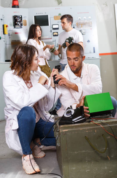 istock Young people with old telephone in lost room-bunker 1325035025