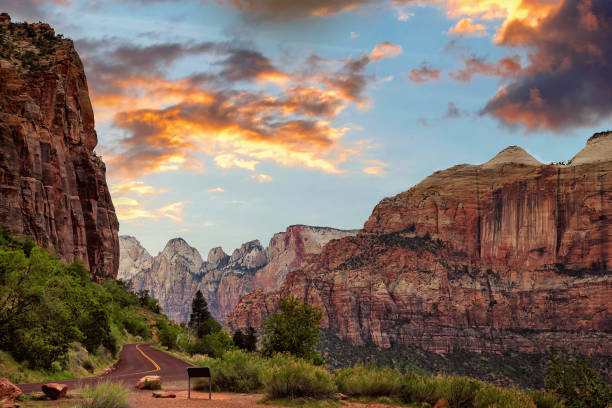 on the road in zion at sunset, utah, usa - asphalt highway desert valley imagens e fotografias de stock