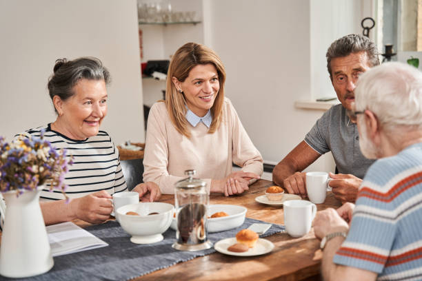 istock People having tea break with each other and chatting with their friendly nurse 1325036100