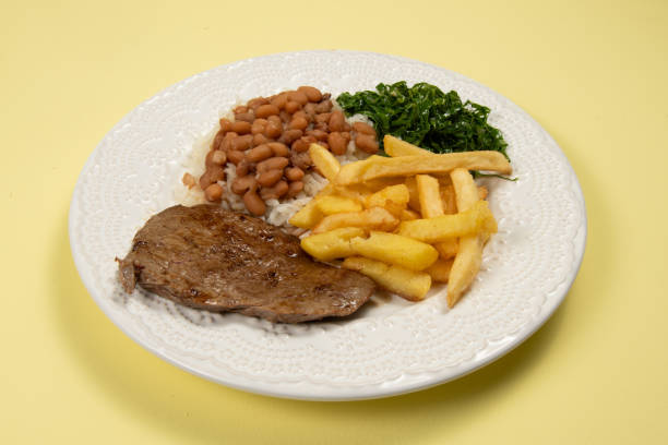 istock typical Brazilian basic dish with rice, beans, steak, french fries and braised cabbage 1325037184
