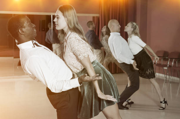 istock Adult pairs dancing tango movements in modern dance studio 1325037643