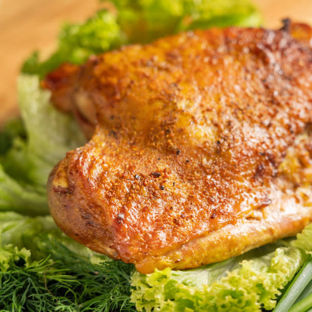 istock Whole roasted turkey thigh. Top view. Close-up turkey dish garnished with herbs. Stone serving board, wooden background. 1325040327