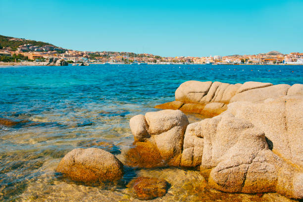 a panoramic view over Palau, in Sardinia, Italy, seen from the Spiaggia di Punta Nera beach, with its characteristic rock formations in the foreground