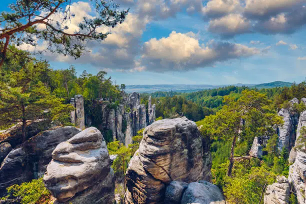 Photo of Prachov rocks (Prachovske skaly) in Cesky Raj region, Czech Republic. Sandstone rock formation in vibrant forest. Prachov Rocks, Czech: Prachovske skaly, in Bohemian Paradise, Czech Republic.