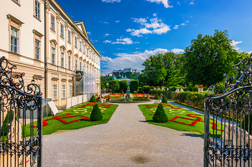 Beautiful view of famous Mirabell Gardens with the old historic Fortress Hohensalzburg in the background in Salzburg, Austria. Famous Mirabell Gardens with historic Fortress in Salzburg, Austria.