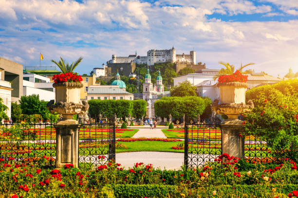 Beautiful View Of Famous Mirabell Gardens With The Old Historic Fortress Hohensalzburg In The Background In Salzburg Austria Famous Mirabell Gardens With Historic Fortress In Salzburg Austria Stock Photo - Download Image