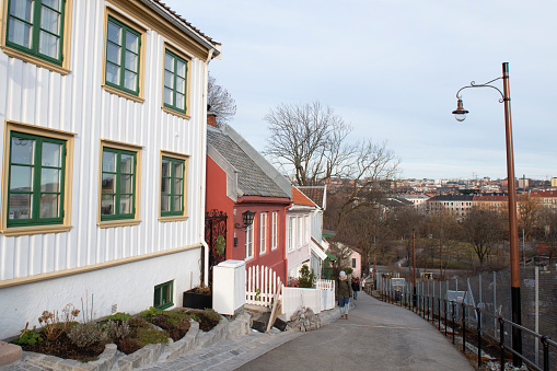 Oslo, Norway - February 24, 2020. People walking on Telthusbakken Street, which is along the historic Pilgrim Path and lined with historic houses, in Oslo, Norway