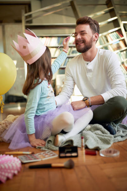 istock A young father enjoys putting on make-up with his daughter while they prepare for ballet training at home. Family, together, home 1325043410