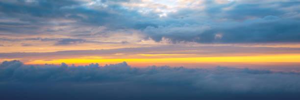 istock Beautiful sunset sky above clouds with dramatic light. Cabin view from airplane. Flying above the clouds. view from the airplane. Beautiful blue sky background with sunset. Sunset above the clouds. 1325043739