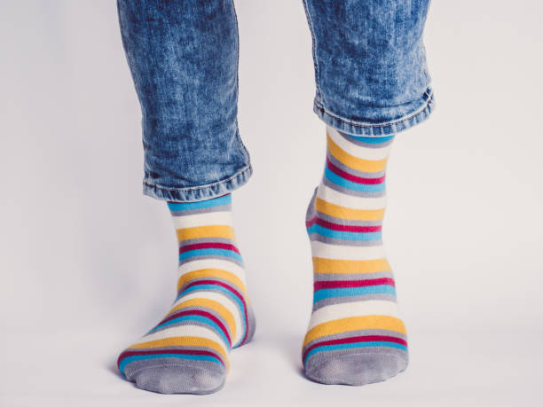 istock Men's legs and bright socks. Without shoes 1325043773