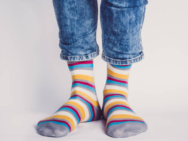 istock Men's legs and bright socks. Without shoes 1325044653