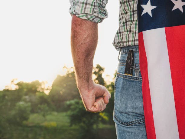 istock Handsome man holding US flag in his hands 1325044816