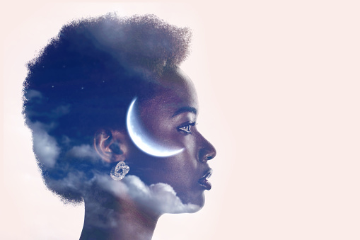 African american black woman profile silhouette portrait with moon and clouds in her head. Sleep and menstrual cycles concept.