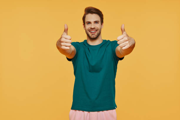 istock Handsome young smiling man in casual clothing looking at camera and gesturing 1325047516