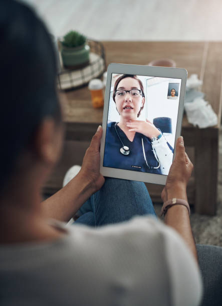 shot of an unrecognizable person on a videocall with a doctor - nurse on phone serious bildbanksfoton och bilder