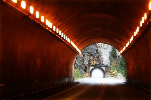 A tunnel that reveals nature in the distance.
