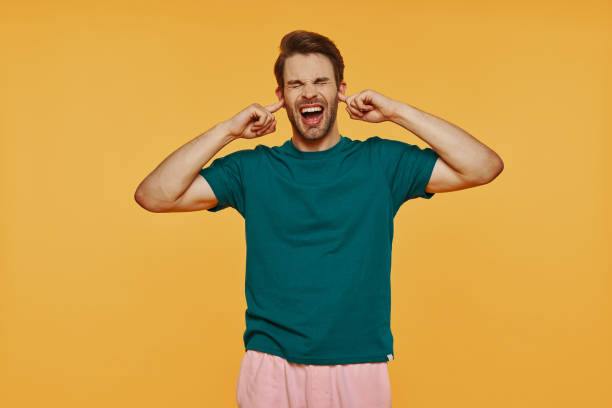 istock Furious young man in casual clothing making a face 1325048912