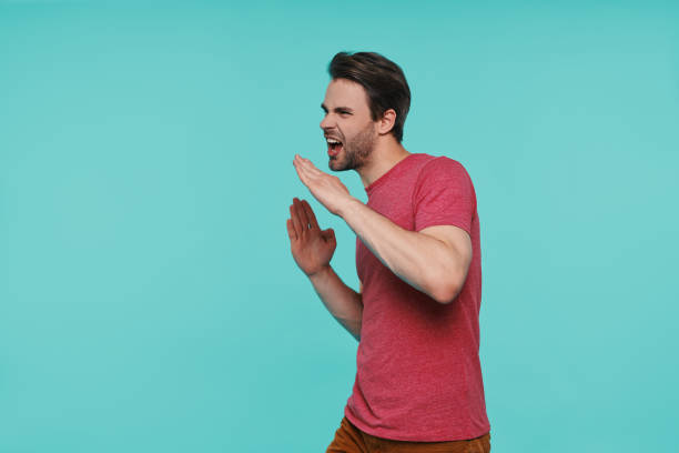 istock Handsome young smiling man in casual clothing gesturing and smiling 1325049015