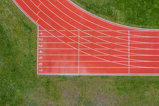 Aerial drone view of a red running track.