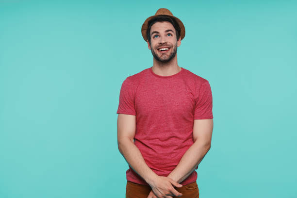 istock Handsome young man in fedora hat looking up and smiling 1325050564