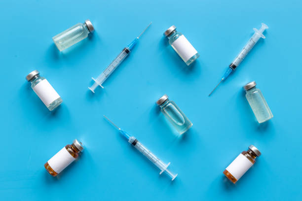 istock Covid vaccine in bottles with syringe. Top view 1325054800