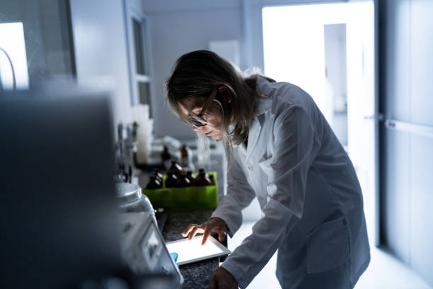mujer científica que trabaja en un laboratorio - scientist chemist doctor lab coat fotografías e imágenes de stock