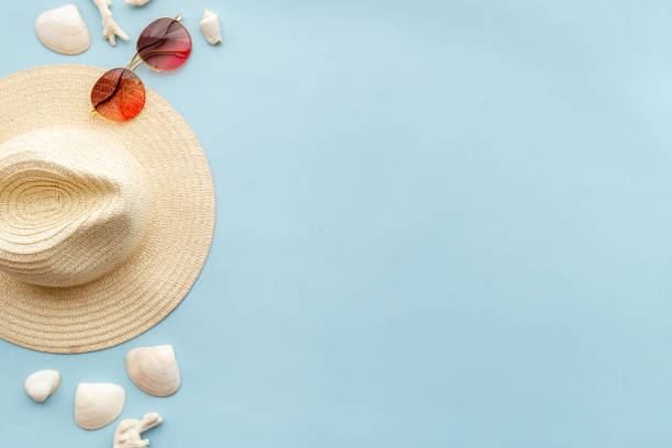 istock Summer sraw beach hat with towel and sunglasses, top view 1325055798