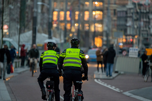 Police Men On Bicycles At Night Amsterdam The Netherlands 16-1-2019