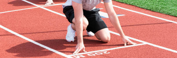 istock Track sprint runner at the 200 meter start 1325056080