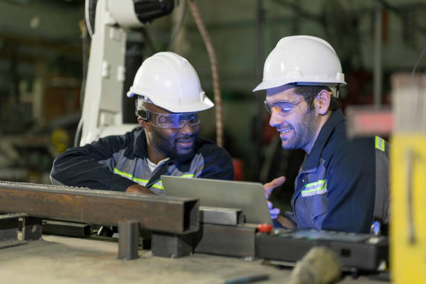istock Two Industry engineers stand and discussion work in the factory workshop. 1325059397
