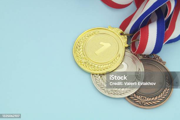 Gold Silver And Bronze Medal On Blue Background Stock Photo - Download Image Now - Bronze Medal, Silver Medal, Medal