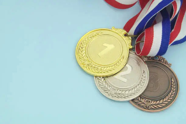 Photo of Gold, silver and bronze medal on blue background