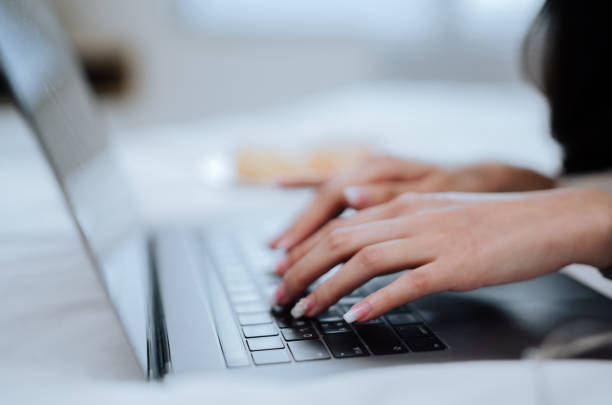 istock Asian woman working from bed on her laptop for COVID-19 quarantine . 1325064171