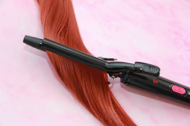 istock women's curl and a curling iron 1325068345