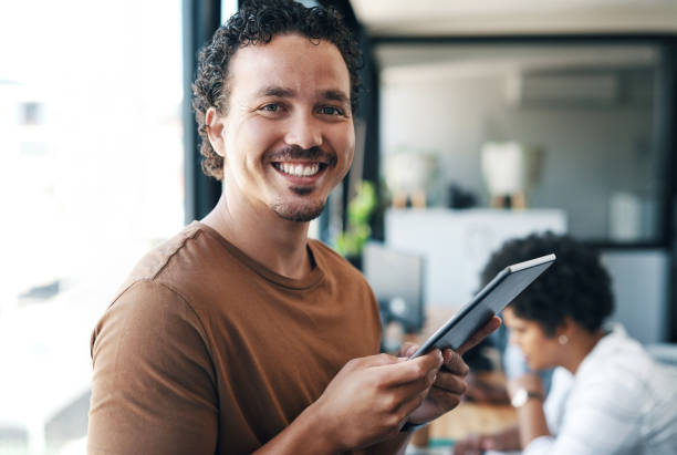 istock Shot of a young businessman using a digital tablet in an office 1325068378