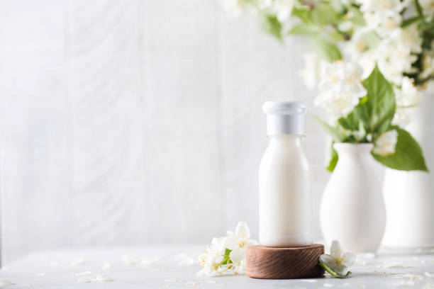 istock Cosmetic detergent with jasmine extract. Mockup of cream, shampoo, soap. Copy space. 1325069143