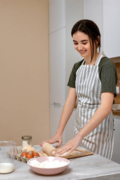 istock Young beautiful housewife cooking on kitchen at home. 1325070708