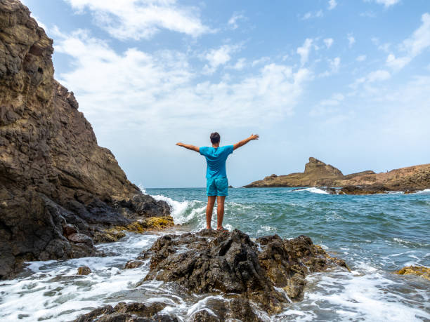 istock Young man from behind looking at the Mediterranean sea with an intense blue 1325072002