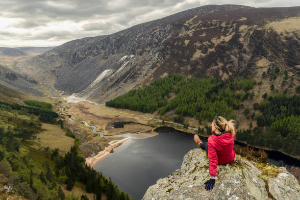 Closeout shot of a Caucasian female on top of a mountain Closeout shot of a Caucasian female on top of a mountain in Glendalough in Ireland killarney lake stock pictures, royalty-free photos & images